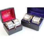 A pair of Edwardian boxed silver napkin rings by Mappin & Webb, London 1908, of circular form with