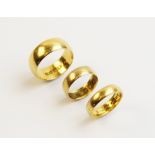 Three 22ct plain polished gold wedding bands, one ring size S, one ring size K, one ring size K ½,
