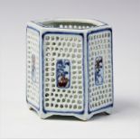 A Chinese porcelain blue and white bitong, 19th/20th century, of hexagonal reticulated form with