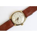 A Winegartens London E.C.2 9ct gold vintage wristwatch, the round cream dial with arabic and baton