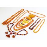 A large quantity of amber and amber-coloured jewellery, to include a butterscotch amber tasseled