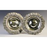 A pair of George IV silver alms dishes by Samuel Hennell, London 1822, each of circular form with