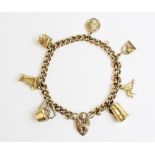 A 9ct gold curb link charm bracelet with attached heart-shaped padlock fastener, 19cm long, with