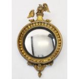 A Regency gilt wood and gesso circular wall mirror, the eagle crest above a 36cm convex mirrored
