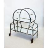 An Art Deco chromed and mirrored tea trolley, the curved chromed box section enclosing two