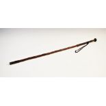 A brass mounted riding crop, early 20th century, the gnarled wood crop with plaited leather grip,