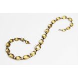 A citrine set riviere necklace, comprising twenty-two oval faceted citrines measuring between 10mm x