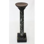 A 19th century vert de mer marble column, designed as a polished circular column upon a square