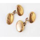 A pair of Victorian 9ct gold cufflinks, marked for 'AJC', Chester 1897, each panel of oval form with