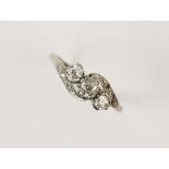 A diamond three-stone ring, comprising a central round old cut diamond weighing approx. 0.25ct, with