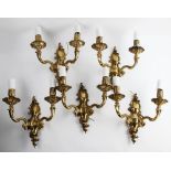 A set of five French brass rococo style twin branch wall light fittings, mid 20th century, of