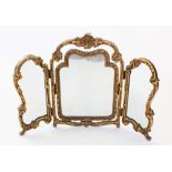 A French style gilt and gesso triple dressing table mirror, mid 20th century, the moulded shell