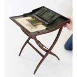 A 19th century mahogany campaign folding writing table, with an enclosed leather stationery