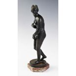 A 19th century Grand Tour classical bronze maiden, modelled standing nude on a circular base upon