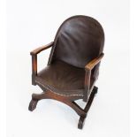 An early 20th century Arts & Crafts stained beech and leatherette open armchair, the hoop back