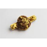 A Victorian 'gold prospectors nugget' brooch, comprising a central raw crystal with a golden