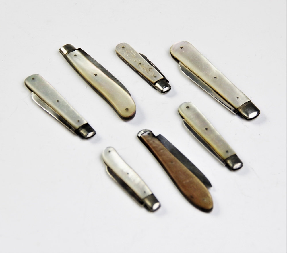 Seven Victorian and later silver bladed folding fruit knives, each with mother of pearl handles, the