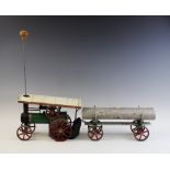 A Mamod model steam traction engine and lumber trailer, the engine with 'Teia' name plate to the