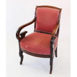A William IV mahogany open library armchair, with a padded back rest above down swept arms