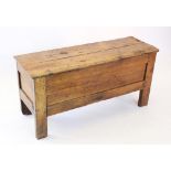 An 18th century and later elm coffer, with a rectangular removable cover above plain panelled sides,