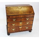 A George II figured walnut bureau, the rectangular cross banded fall front enclosing an oak