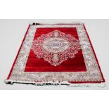 A woven bamboo silk rug, with bespoke floral medallion against a red ground, full pile, 240cm x