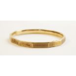 A 9ct gold faceted bangle, Chester 1911, with engine turned decoration to exterior, 7.8cm x 6.8cm,