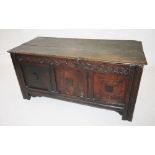 A late 17th/early 18th century oak coffer, the two plank moulded top above a guilloche carved frieze