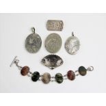 An agate panel bracelet, comprising six oval carved panels joined by beaded links, 18cm long,