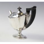 An Edwardian silver teapot by Thomas Bradbury & Sons, London 1904, of shaped oval form on pedestal