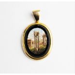 A Victorian micromosaic pendant, the central panel depicting a landscape of ancient ruins, set to