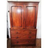 A Victorian mahogany linen press of small proportions, the moulded cornice above two panelled