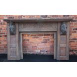 A 17th century style carved oak fire surround, 19th century, the rectangular shelf above panels