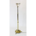 An early 20th century Art Nouveau brass standard lamp, the adjustable and graduated column raised