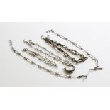 A selection of four silver chains, measuring between 26cm long and 39cm long, together with a
