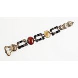 A Scottish agate 'buckle' bracelet, comprising carved agate panels in assorted colours set