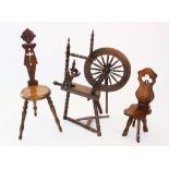 A reproduction oak spinning wheel, 20th century, with a 45cm spindled wheel, raised upon bobbin