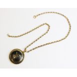 A Victorian 9ct gold and tortoiseshell pendant, the circular domed pendant with gold coloured inlaid
