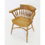 A 19th century style blonde elm and ash smokers bow elbow chair, 20th century, the 'C' shaped arm