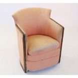 A late 19th/early 20th century tub chair, the concave padded back rest flanked by angular arm