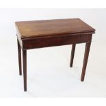 An early 19th century mahogany folding tea table, the rectangular top above a plain frieze, raised