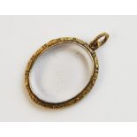 A Victorian 15ct gold locket pendant, of oval form with two transparent glass windows to each