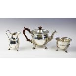 An Edwardian three piece silver tea service by Wakely & Wheeler, London 1906, comprising a teapot,