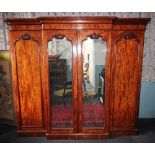 A Victorian mahogany breakfront four door wardrobe, with a cavetto cornice above a pair of central