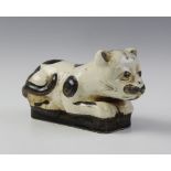 A Chinese Cizhou style cat pillow, realistically modelled as a recumbent cat, 22cm long