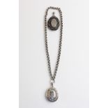 A Victorian white metal locket pendant, with engraved initials 'EC' and glazed compartments to
