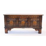 A 17th century style oak coffer, mid 20th century, the rectangular moulded top above a nulled frieze