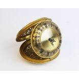 A Jaeger recital travelling alarm clock, with domed circular gilt dial and black enameled roman