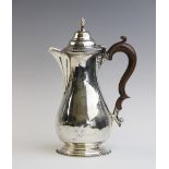 A George V silver hot water jug by George Nathan & Ridley Hayes, Chester 1914, of baluster form on