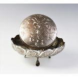 A Persian white metal tripod bowl, of circular scalloped form on three feet, with engraved and